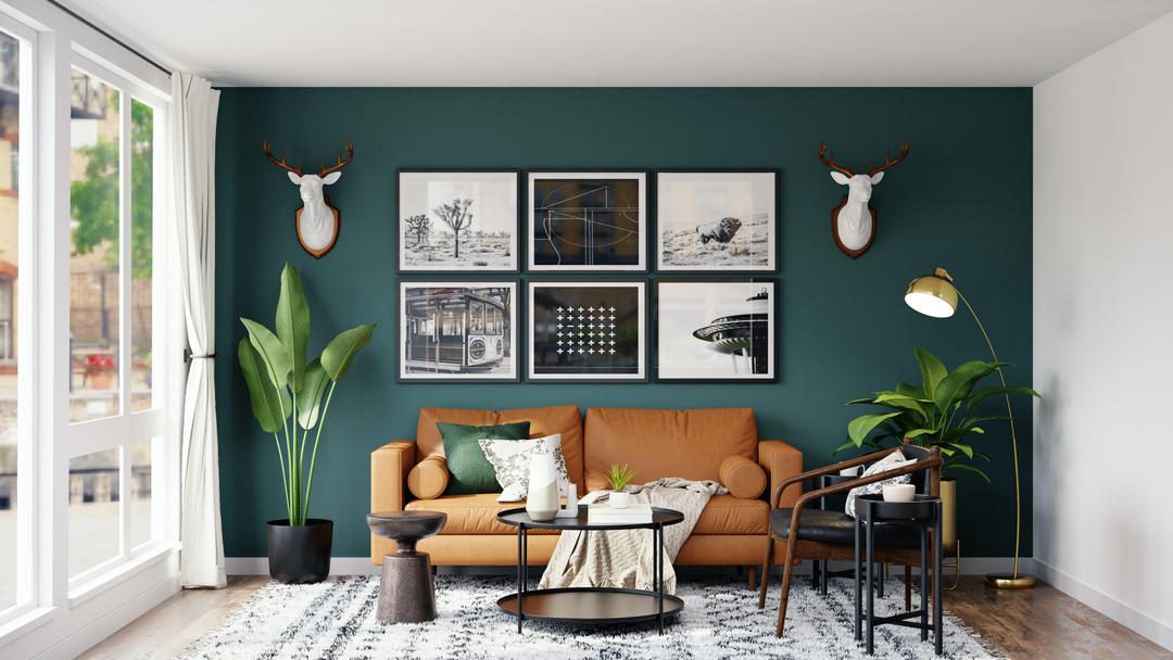 Salon avec un mur vert foncé pour faire paraitre la pièce plus grande