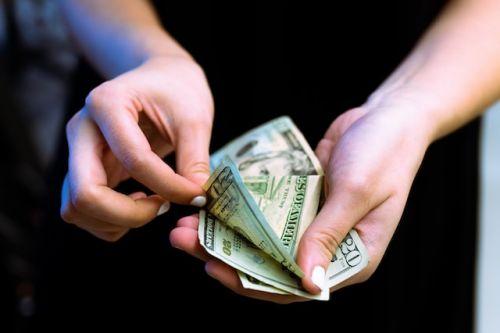 Person counting money to pay his deductible