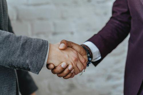 Investor shaking the hand of a property management expert