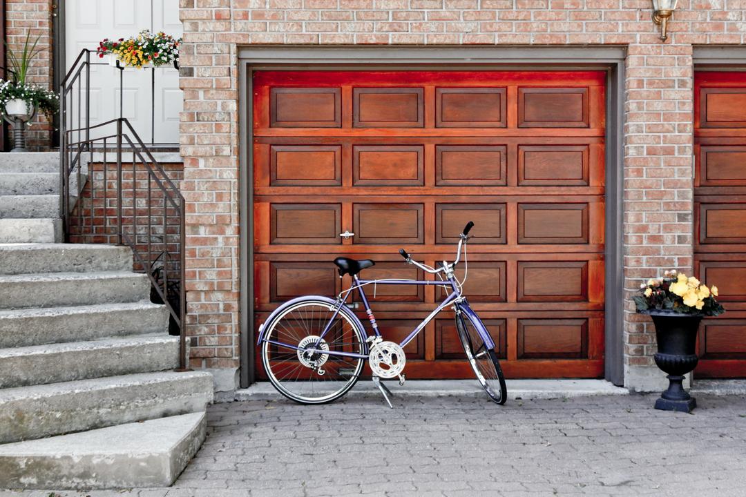 Un vélo laissé devant un garage