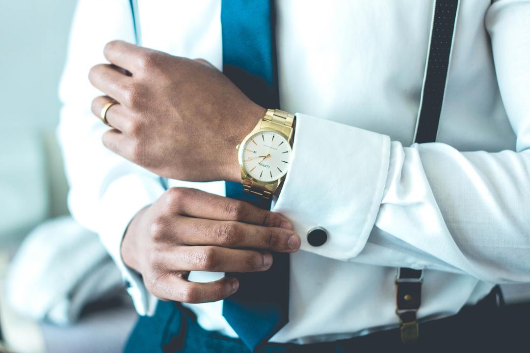 A man with a dress shirt and a watch