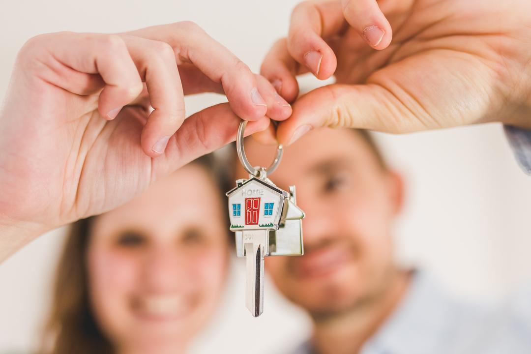 A couple holding the keys to their new house