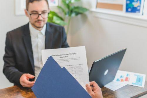 Mortgage broker looking at an application form for a loan