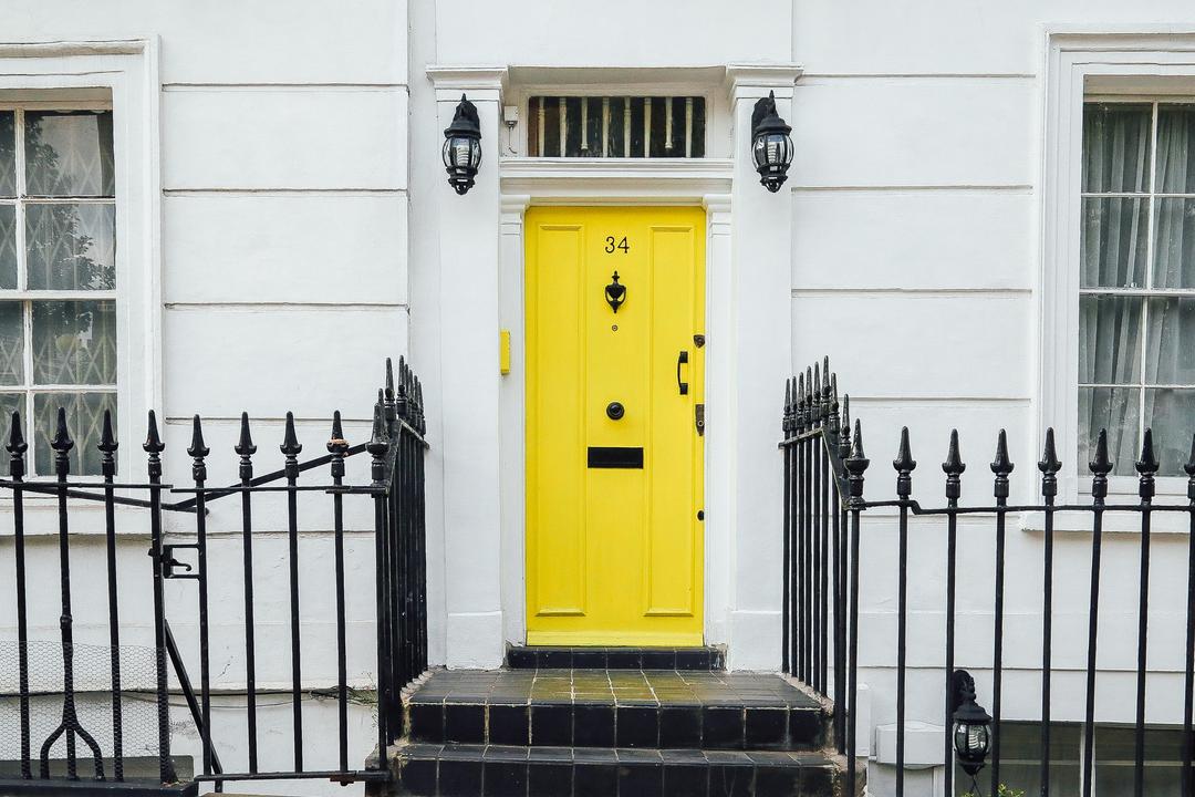 A white house with a yellow door