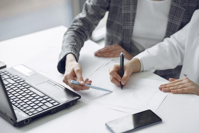 Two people looking at a computer