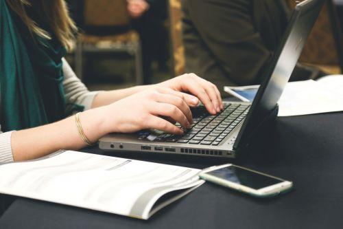 WOman writing on computer
