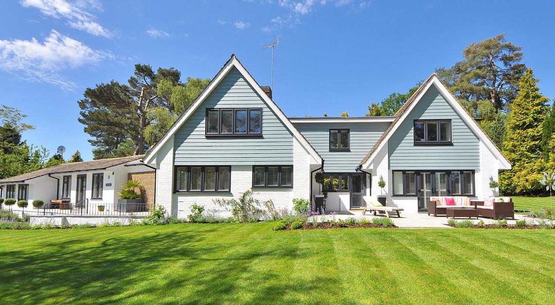 A beautiful white and green house