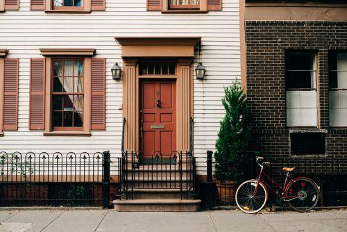 the front of a house with a red door