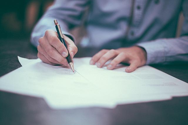 A man signing important papers