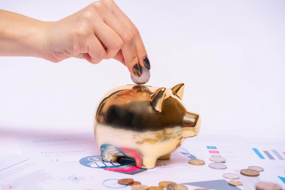Woman putting money in a piggybank