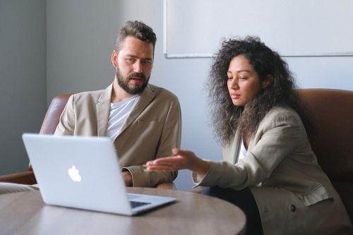 Mortgage broker explaining the home equity line of credit to a client on a computer