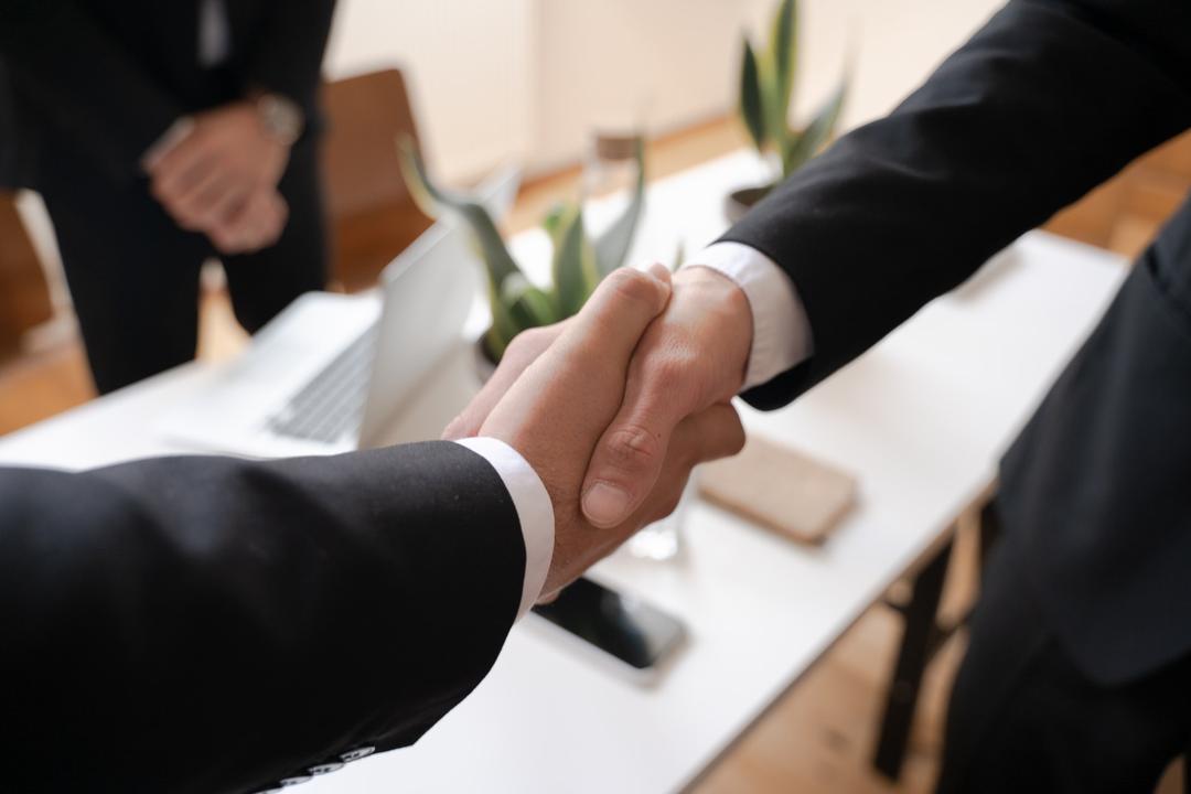 Un courtier en assurance serrant la main d'un client