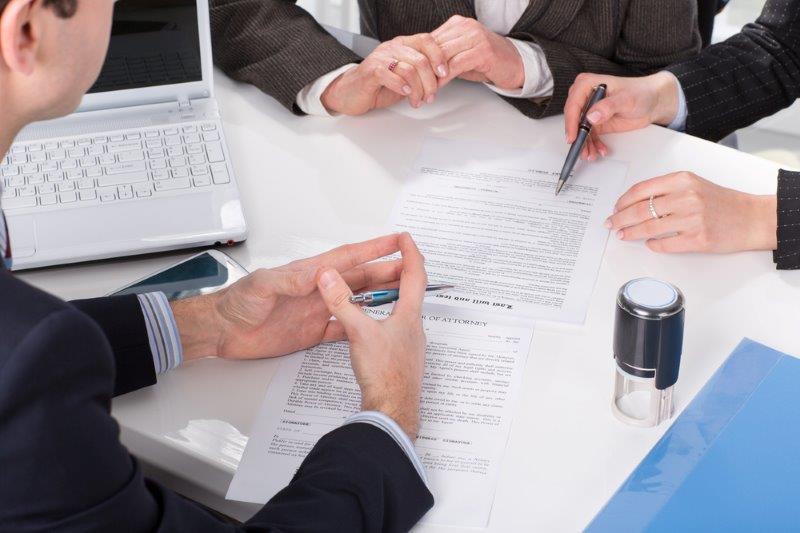 Professionals signing important documents