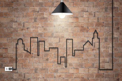 Electrical wire creating a town pattern on a brick wall