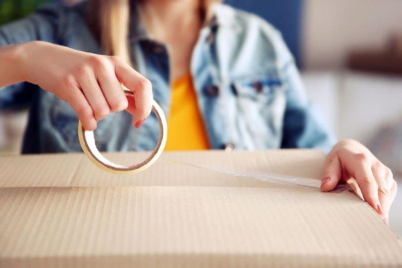 personne qui prépare boite déménagement_person preparing a box to move to a new house