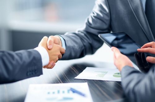 Commercial mortgage broker shaking hands with a client