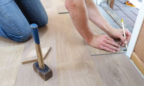Person repairing a floor