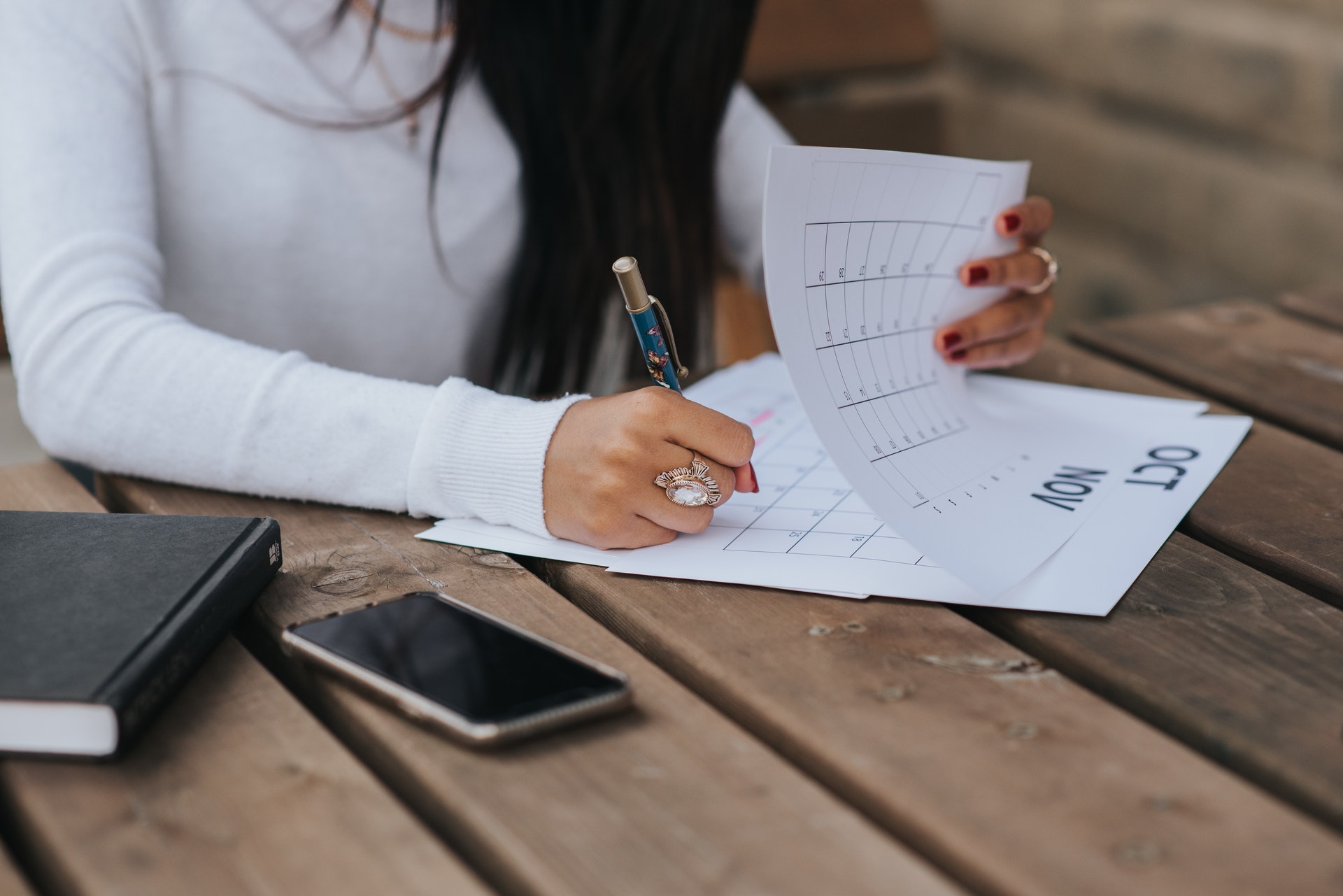 Woman writing on a calendar