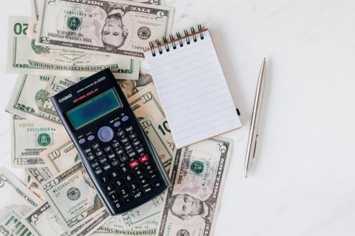 Calculator, notebook and money