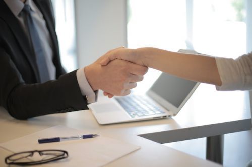 Mortgage broker shaking the hand of a client