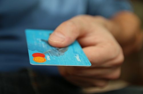 Person handing credit card